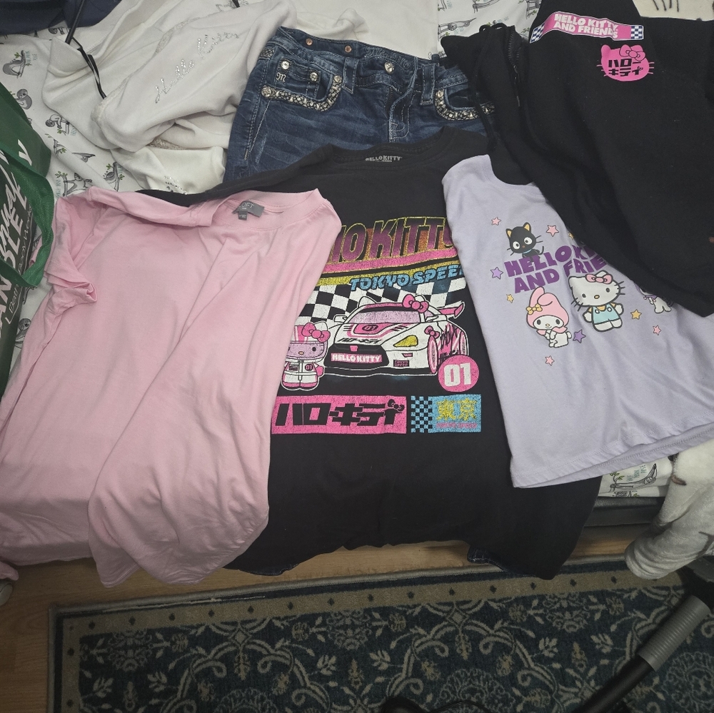 Lot of Hello Kitty clothes plus a pair of Miss Me jeans.